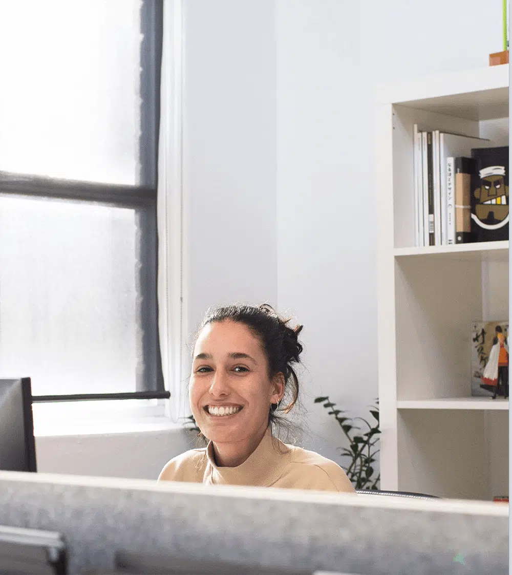 Woman sitting at desk smiling