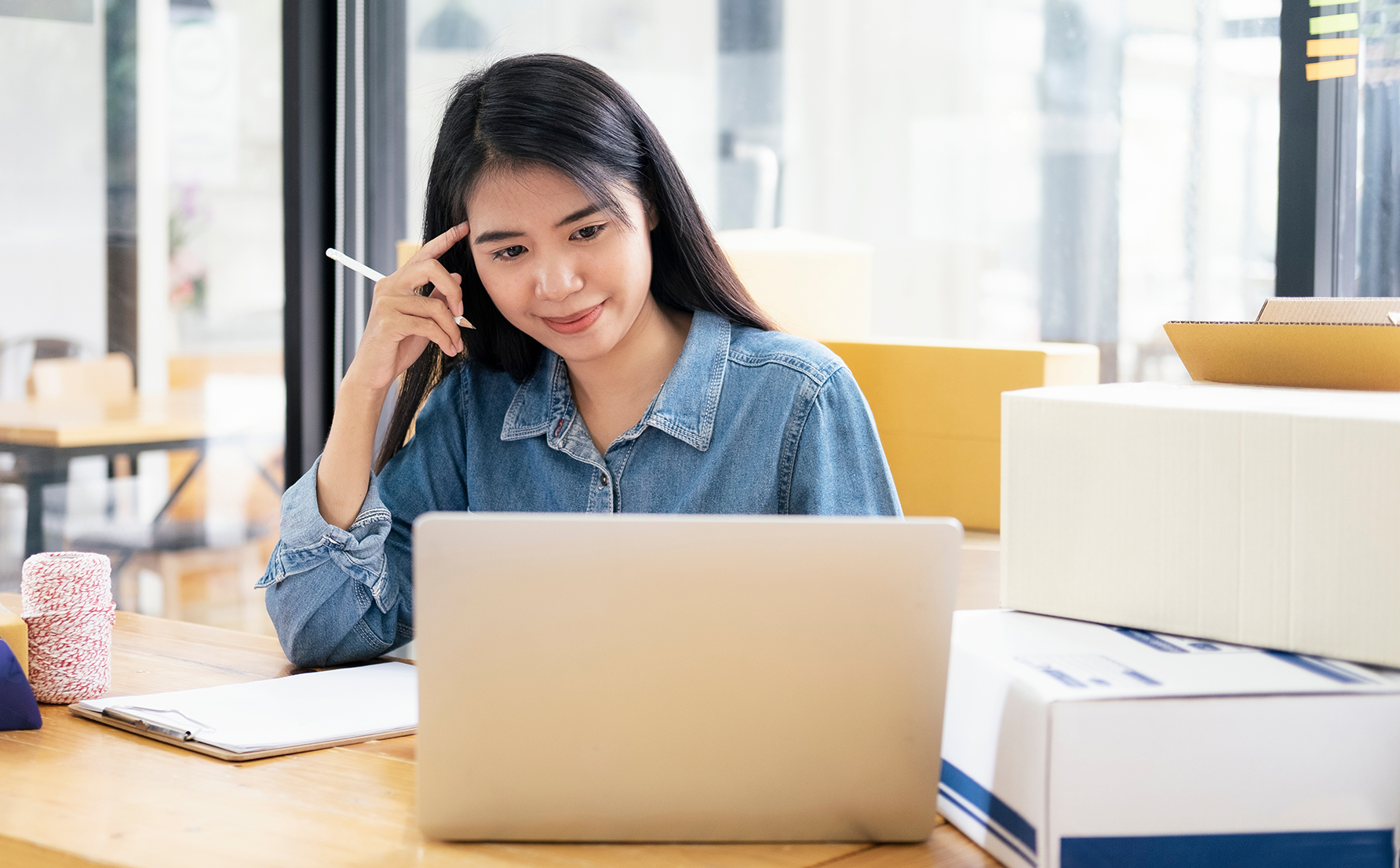 Young Asian woman working on commerce storefront