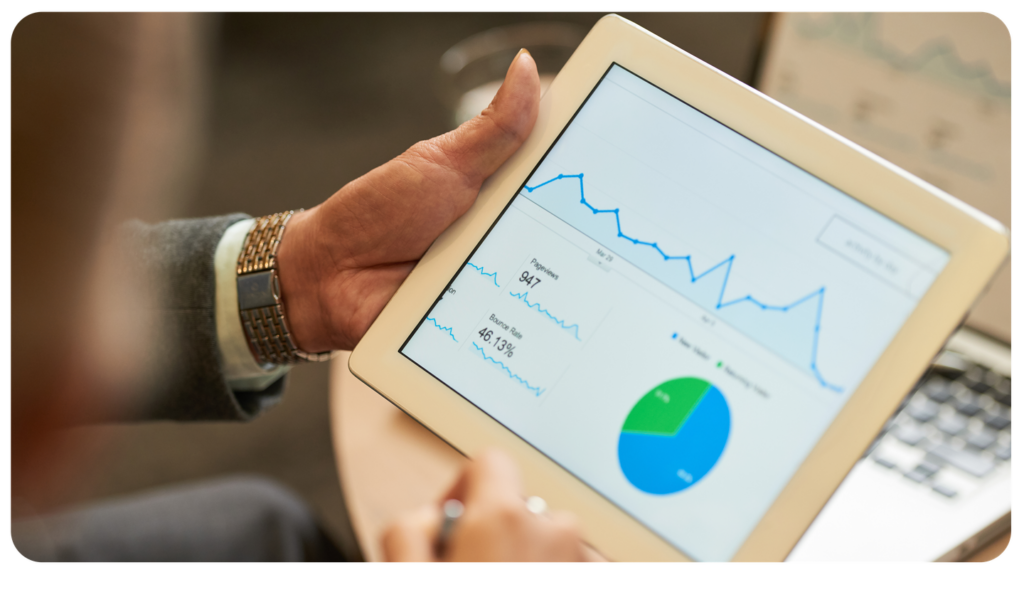 Person holding a tablet with a graph