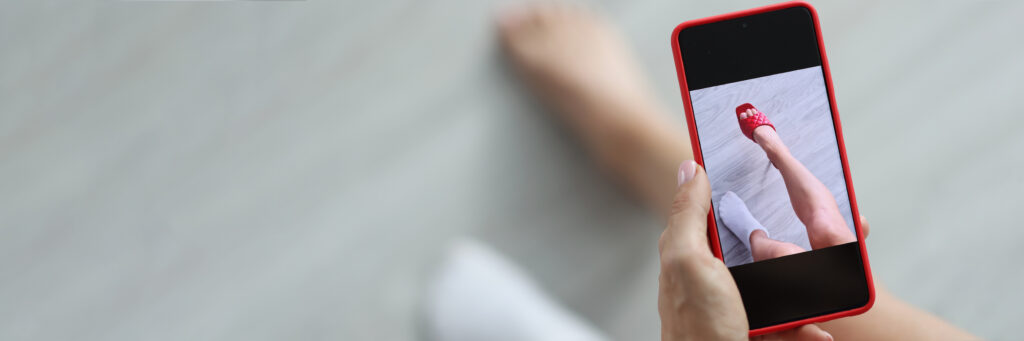 person trying on a red pump virtually