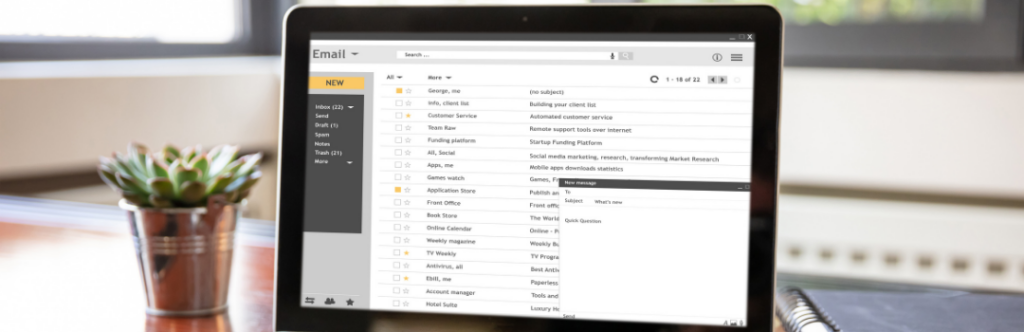 laptop on a table with email showing
